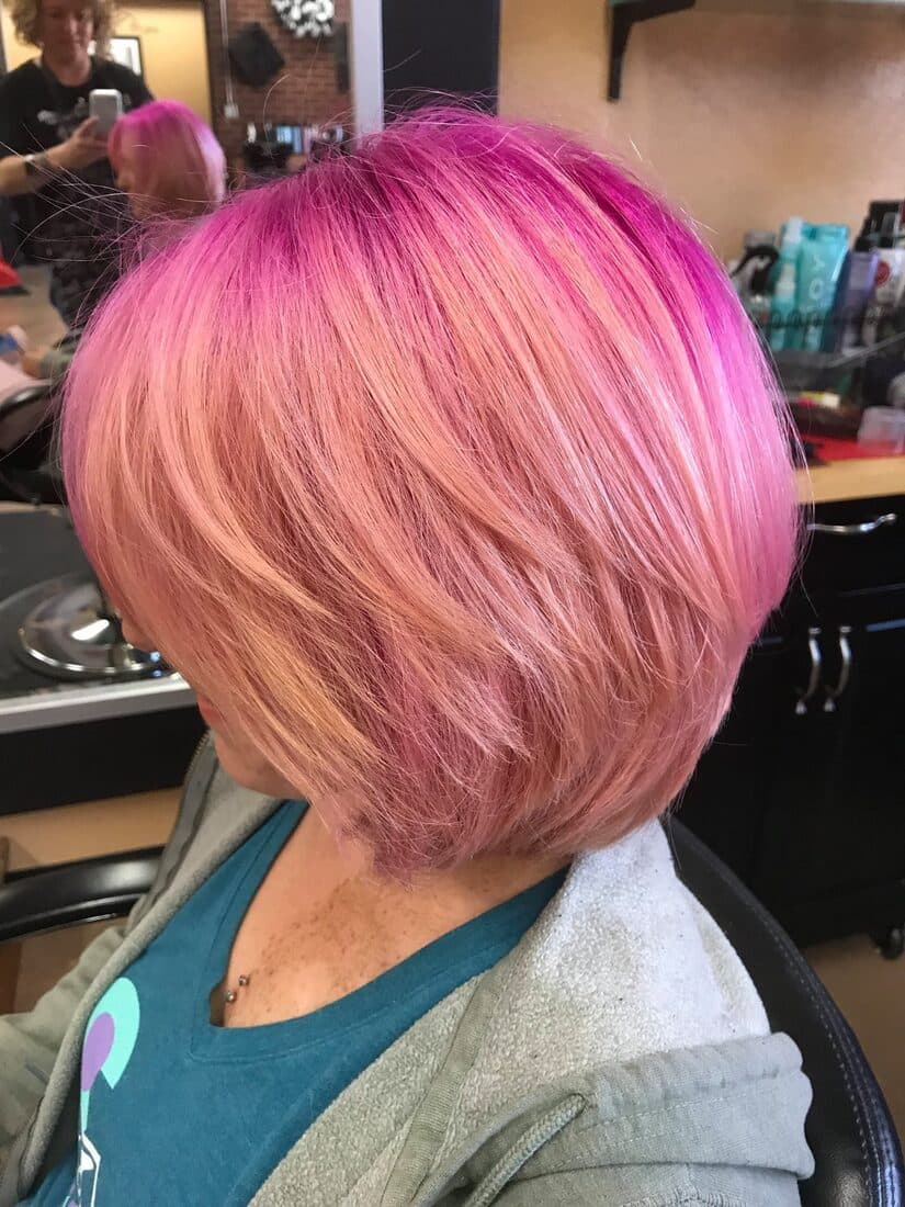 Vivid pink bob cut and colored at Bombshell Salon
